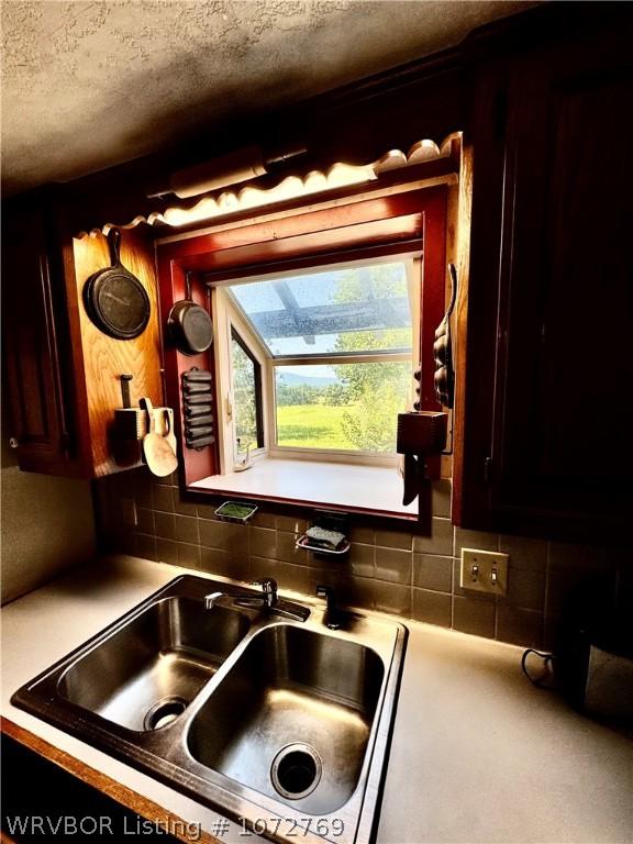 kitchen with sink and a textured ceiling