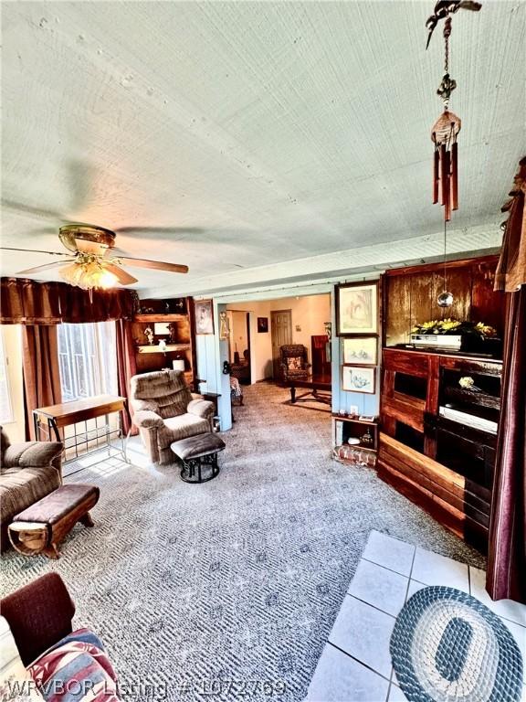 living room with light carpet and ceiling fan