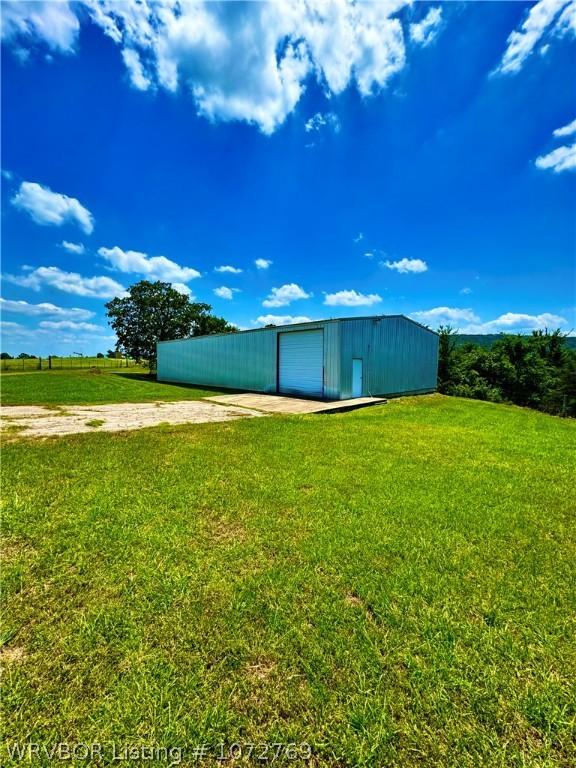 view of outbuilding featuring a yard