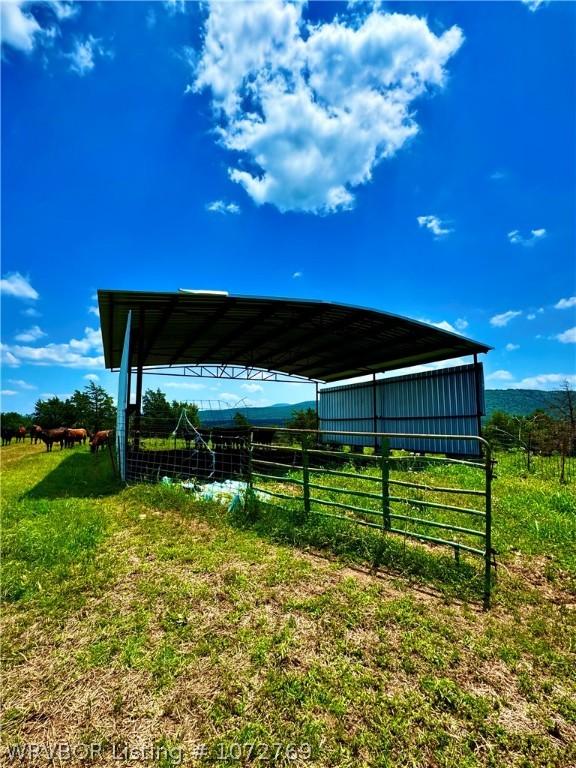 view of yard featuring a rural view and an outdoor structure