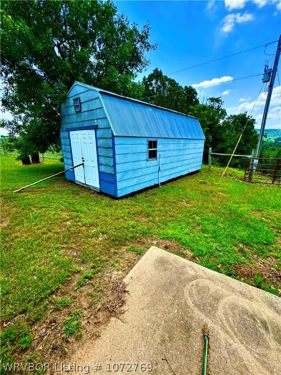 view of outbuilding with a yard