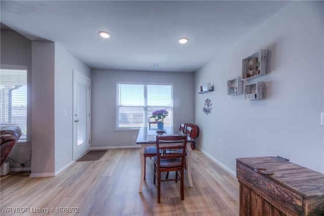 dining space with light hardwood / wood-style floors