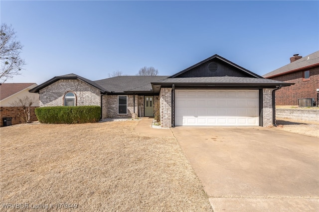 ranch-style house with driveway, roof with shingles, a garage, and brick siding