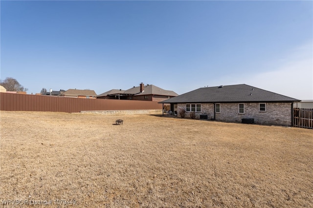 view of yard featuring cooling unit and fence