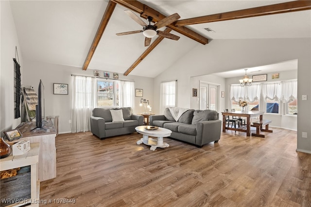 living room with visible vents, wood finished floors, beamed ceiling, baseboards, and ceiling fan with notable chandelier