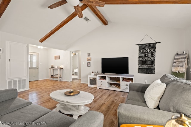 living room featuring light wood-style floors, visible vents, vaulted ceiling with beams, and a ceiling fan