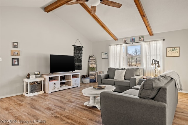 living room with a ceiling fan, baseboards, beam ceiling, and wood finished floors