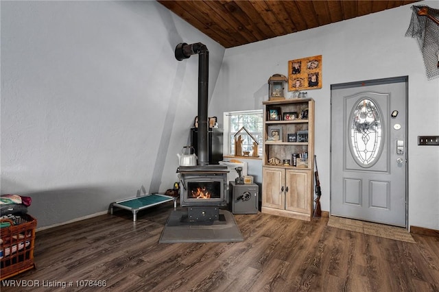 foyer entrance with wooden ceiling, a wood stove, dark hardwood / wood-style flooring, and lofted ceiling