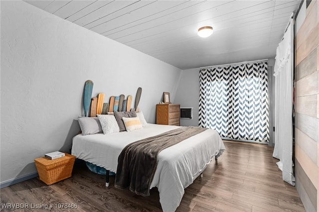 bedroom featuring wood-type flooring and wood ceiling