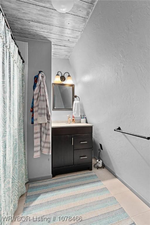 bathroom with wooden ceiling, vanity, and lofted ceiling