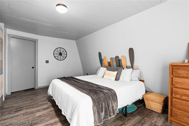 bedroom with dark wood-type flooring