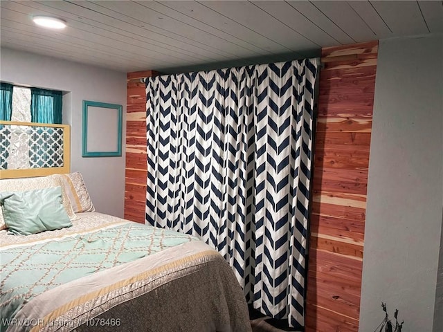 unfurnished bedroom featuring wood ceiling and wood walls