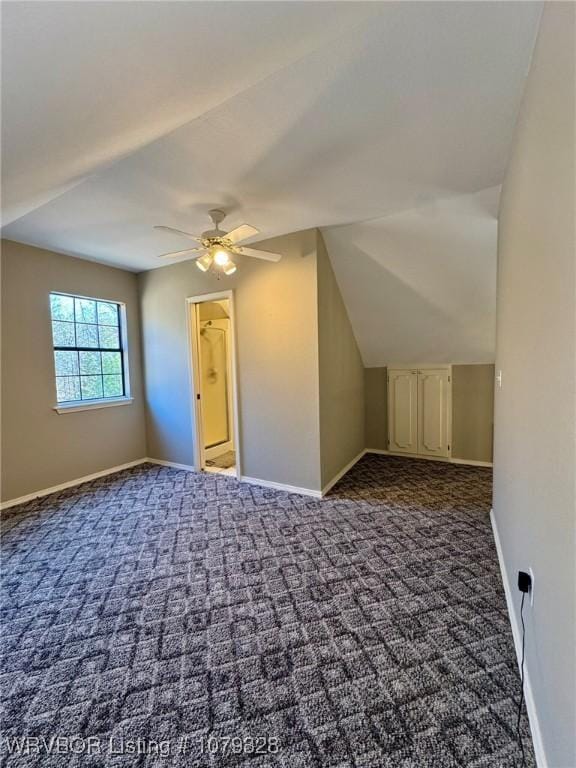 additional living space featuring carpet, ceiling fan, lofted ceiling, and baseboards