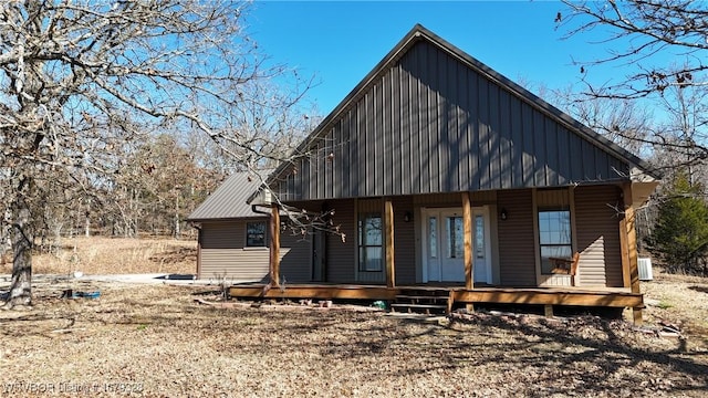 view of front of house featuring board and batten siding, covered porch, and central AC