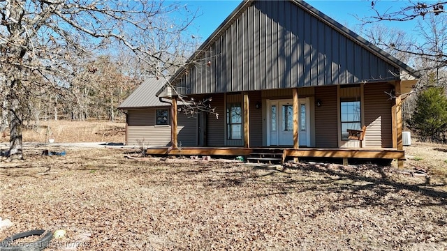 view of front of house with covered porch, central AC unit, and board and batten siding