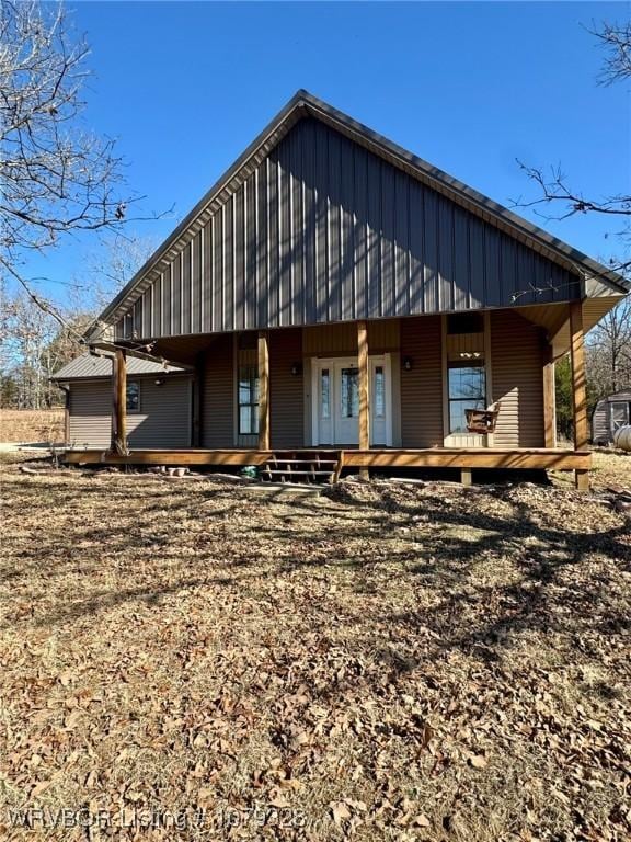 back of property featuring covered porch