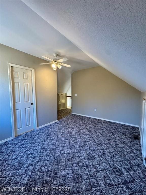 bonus room featuring carpet, lofted ceiling, visible vents, ceiling fan, and a textured ceiling