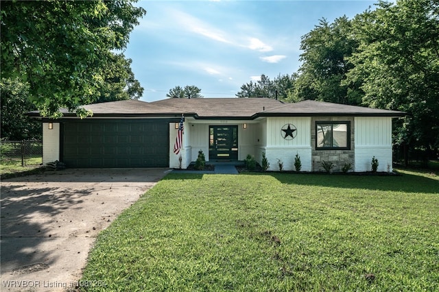 908 N 5th Ter, Barling, AR 72923 - ranch-style house with an attached garage, concrete driveway, brick siding, and french doors