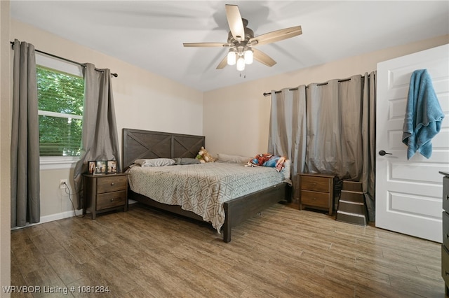908 N 5th Ter, Barling, AR 72923 - bedroom featuring wood finished floors and a ceiling fan
