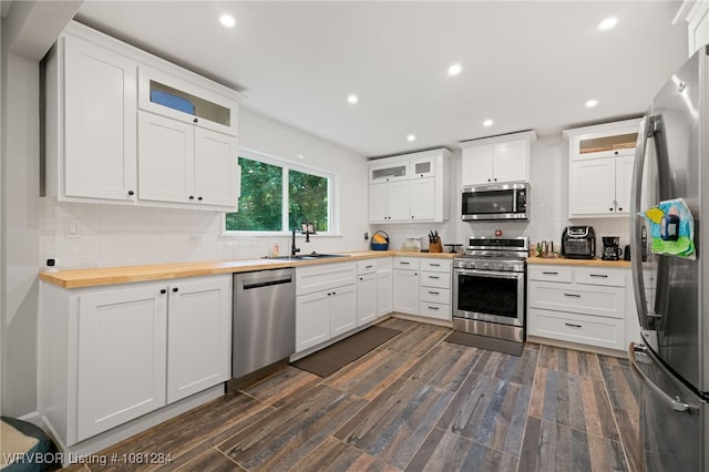 908 N 5th Ter, Barling, AR 72923 - kitchen featuring stainless steel appliances, wooden counters, a sink, decorative backsplash, and white cabinetry
