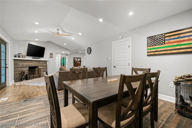 908 N 5th Ter, Barling, AR 72923 - dining area with a ceiling fan, wood finished floors, a fireplace, lofted ceiling, and baseboards