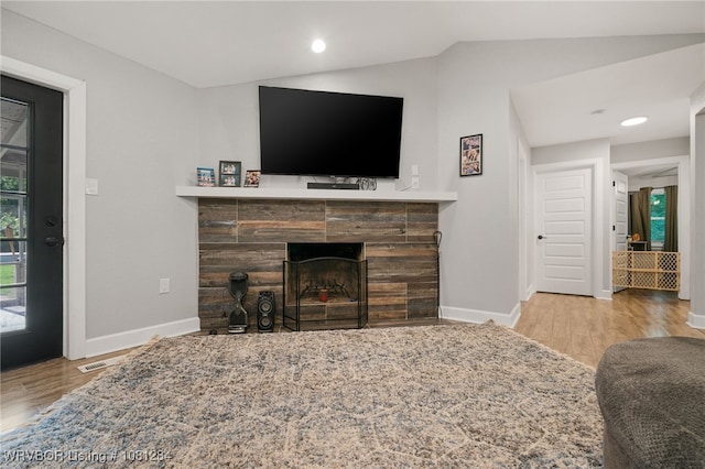 908 N 5th Ter, Barling, AR 72923 - living room with a tiled fireplace, wood finished floors, baseboards, lofted ceiling, and recessed lighting