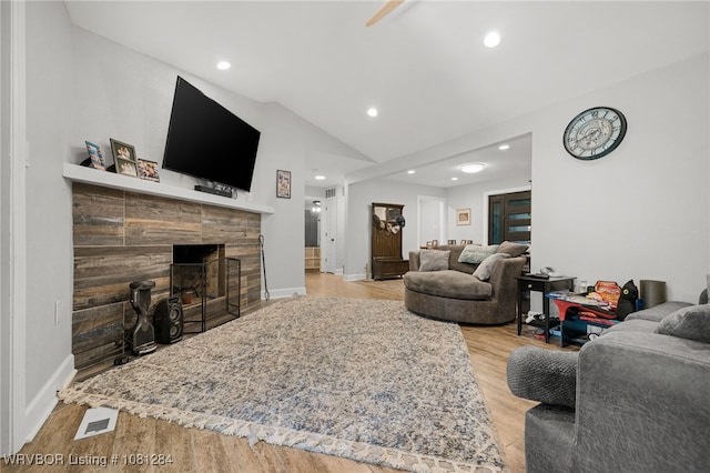 908 N 5th Ter, Barling, AR 72923 - living area with lofted ceiling, wood finished floors, recessed lighting, a fireplace, and baseboards