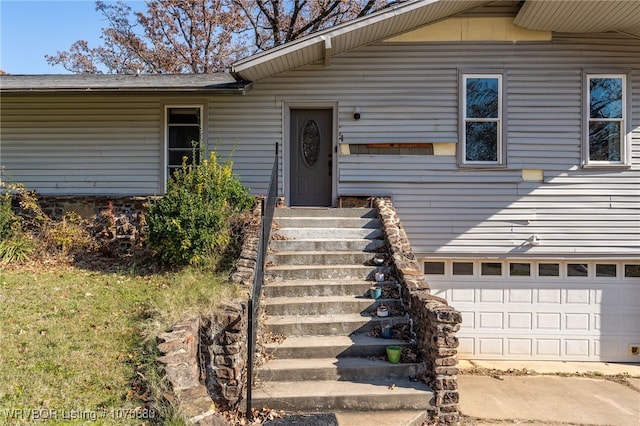 view of exterior entry with a garage