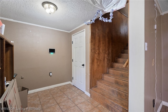 interior space with ornamental molding and a textured ceiling