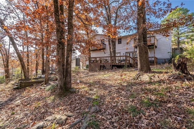 view of yard with a balcony and a deck