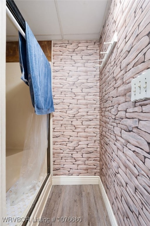 bathroom featuring hardwood / wood-style floors and a drop ceiling