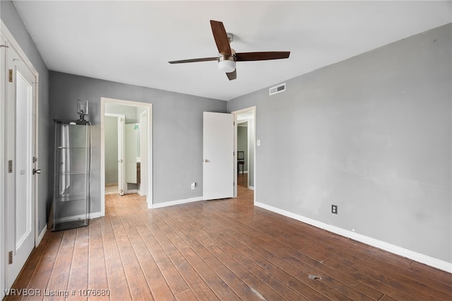 unfurnished bedroom featuring wood-type flooring and ceiling fan