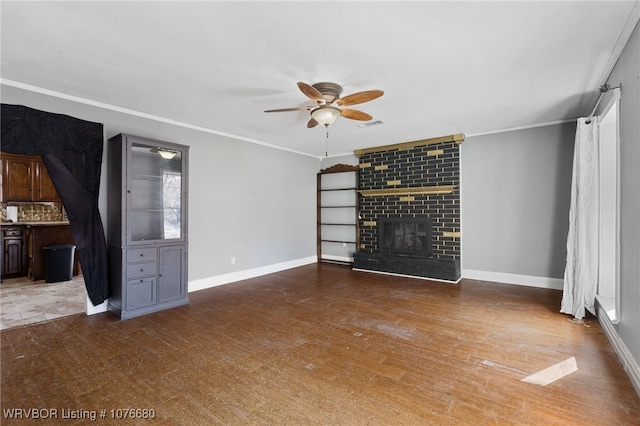 unfurnished living room with ceiling fan, a fireplace, hardwood / wood-style flooring, and ornamental molding