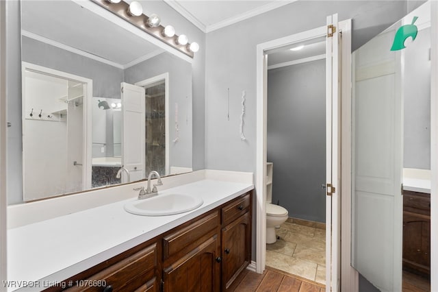 bathroom featuring vanity, toilet, and ornamental molding