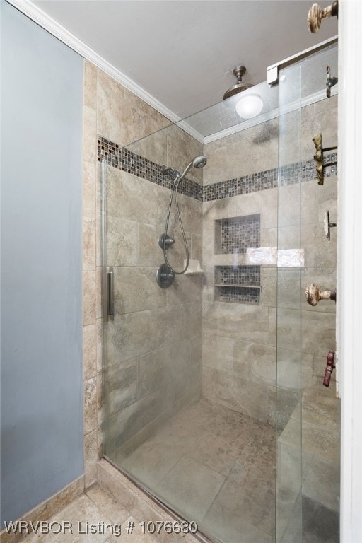 bathroom with tile patterned floors, crown molding, and walk in shower