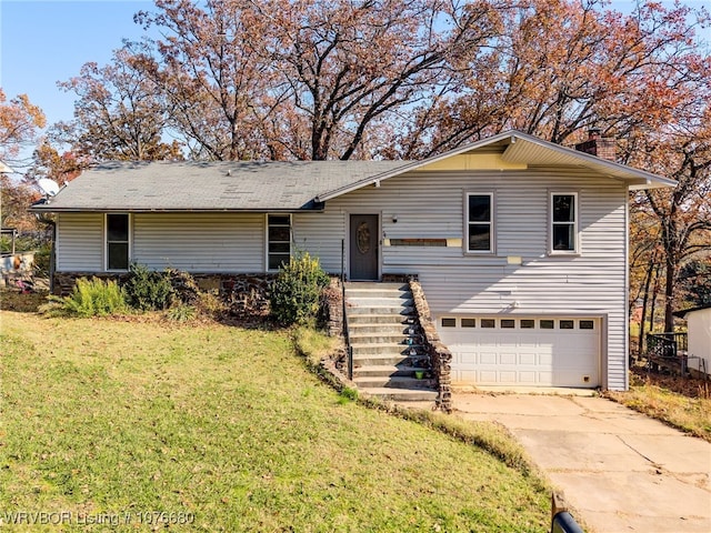 view of front of house featuring a garage and a front lawn