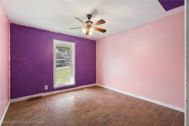 empty room featuring dark hardwood / wood-style floors and ceiling fan