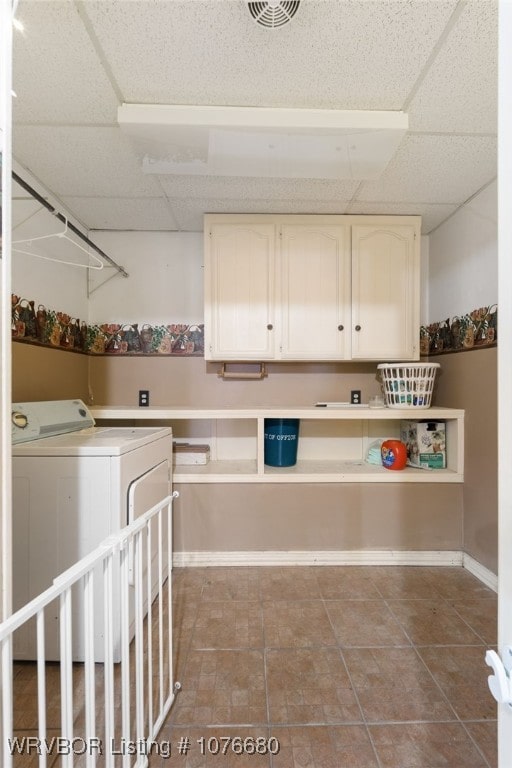 laundry room featuring cabinets and washer / dryer