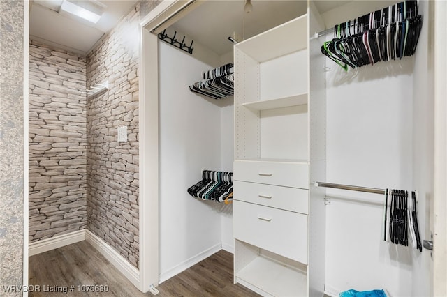 walk in closet featuring dark wood-type flooring