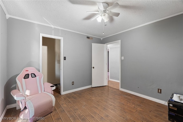 sitting room with dark hardwood / wood-style floors, ceiling fan, and ornamental molding