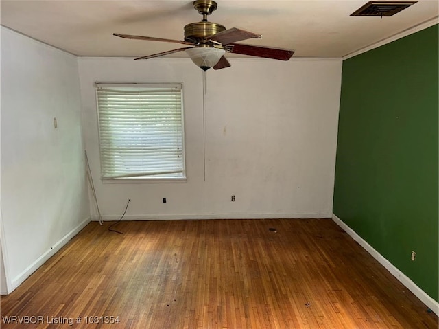 2006 Wolfe Ln, Fort Smith, AR 72901 - unfurnished room featuring wood-type flooring, a ceiling fan, baseboards, and ornamental molding