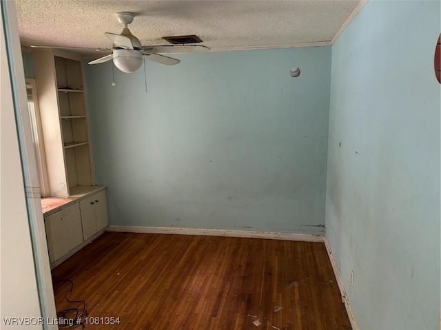 2006 Wolfe Ln, Fort Smith, AR 72901 - spare room with dark wood-style flooring, ceiling fan, a textured ceiling, and baseboards