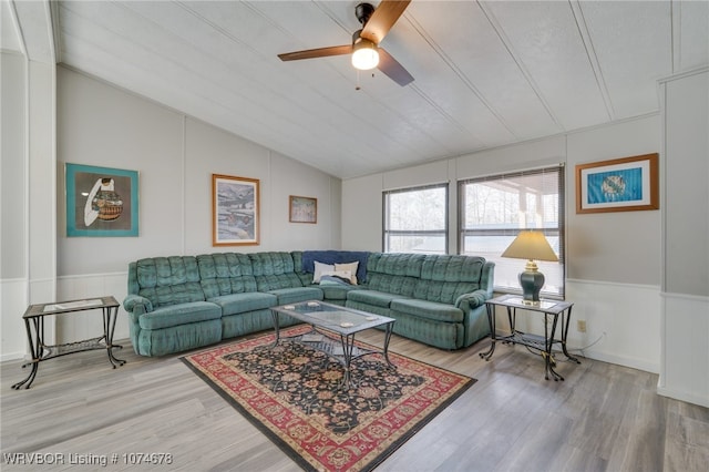 living room with hardwood / wood-style floors, ceiling fan, and lofted ceiling