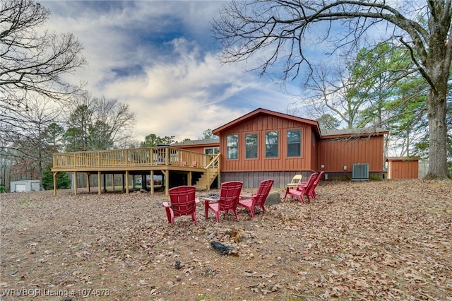 back of house featuring central AC unit and a deck