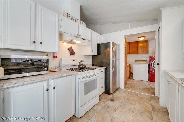 kitchen featuring white cabinetry, washer / clothes dryer, white range with gas cooktop, and vaulted ceiling