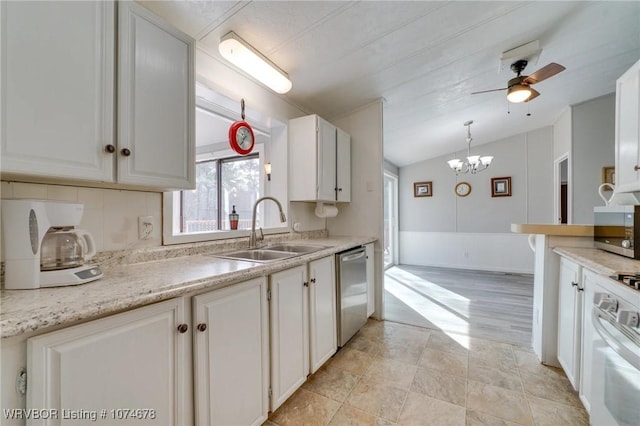 kitchen with stainless steel dishwasher, ceiling fan with notable chandelier, vaulted ceiling, sink, and white cabinets