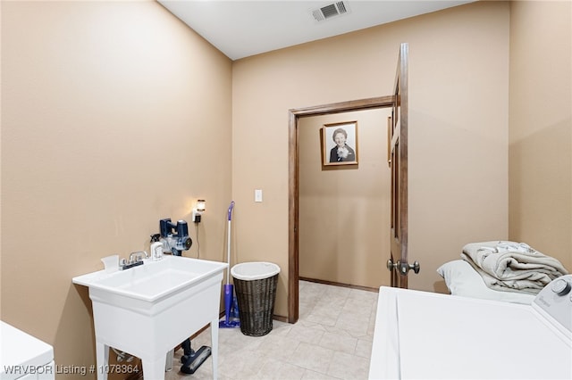 clothes washing area with washer and dryer and sink