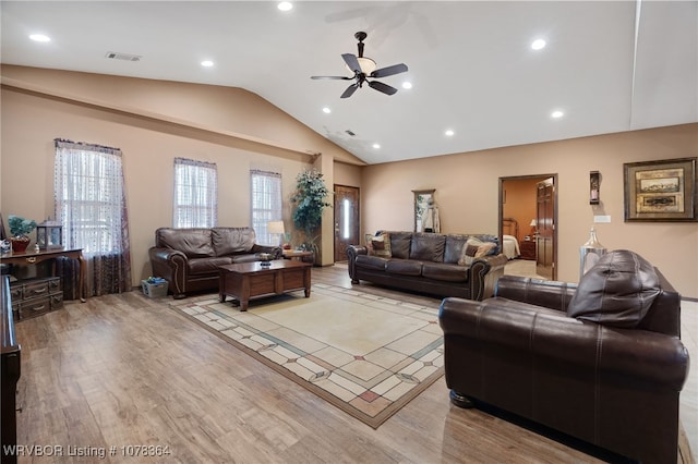 living room featuring light wood-type flooring, vaulted ceiling, and ceiling fan