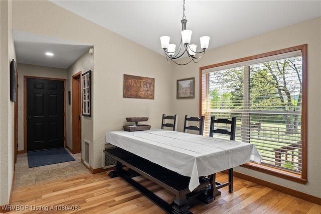1450 Ulmer St, Greenwood, AR 72936 - dining space with light wood-style flooring, lofted ceiling, baseboards, and an inviting chandelier