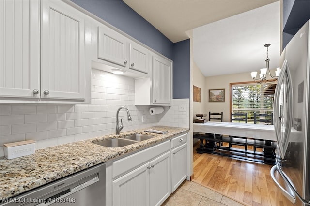 1450 Ulmer St, Greenwood, AR 72936 - kitchen with appliances with stainless steel finishes, a chandelier, a sink, and white cabinetry